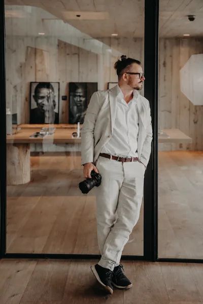 Jan v. Deichen, Hochzeitsfotograf aus Braunschweig, im hellen Leinenanzug mit Kamera